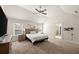 Bright primary bedroom boasts neutral walls, carpet, natural light from a large window at 4735 Belcrest Way, Cumming, GA 30040