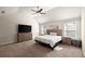 Bright primary bedroom features neutral walls, carpet, and a large window at 4735 Belcrest Way, Cumming, GA 30040