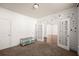 Neutral bedroom showcasing french doors, an interesting accent wall and a large bunny cage at 4735 Belcrest Way, Cumming, GA 30040