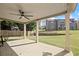 The covered patio features an overhead fan and concrete flooring overlooking the large fenced backyard at 4735 Belcrest Way, Cumming, GA 30040