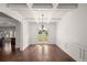 Elegant dining area with hardwood floors, white trim, and a modern chandelier at 4735 Belcrest Way, Cumming, GA 30040