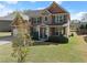 Beautiful two-story brick home with a well-maintained lawn and shrubbery at 4735 Belcrest Way, Cumming, GA 30040