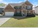 Charming two-story brick home with well-manicured lawn and a two-car garage at 4735 Belcrest Way, Cumming, GA 30040