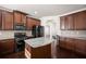 Well-lit kitchen featuring an island, modern appliances, dark hardwood floors, and stylish cabinetry at 4735 Belcrest Way, Cumming, GA 30040