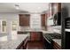 Modern kitchen featuring dark cabinets, stainless steel appliances, and granite countertops at 4735 Belcrest Way, Cumming, GA 30040