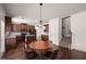 Open concept kitchen with dark cabinets, island with granite counter, and eat-in table set at 4735 Belcrest Way, Cumming, GA 30040