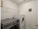 Efficient laundry room with modern washer and dryer, plus storage shelving at 4735 Belcrest Way, Cumming, GA 30040