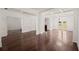 Open-concept living room with hardwood floors and white trim at 4735 Belcrest Way, Cumming, GA 30040