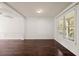 Cozy living room with hardwood floors and a large window at 4735 Belcrest Way, Cumming, GA 30040