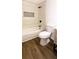 Bright bathroom featuring a modern wood vanity and a white tiled shower and tub at 1333 Briar Ridge Ln, Jonesboro, GA 30238