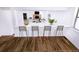 Modern kitchen bar area with seating, hardwood floors, and an open view to the living room at 1333 Briar Ridge Ln, Jonesboro, GA 30238
