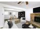 Cozy living room features a brick fireplace, modern furniture, a ceiling fan, and a stylish workspace at 1333 Briar Ridge Ln, Jonesboro, GA 30238