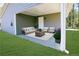 Covered outdoor patio staged with patio furniture set and blue planters on green grass at 1333 Briar Ridge Ln, Jonesboro, GA 30238