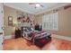 Cozy bedroom with sports decor, hardwood floors, and ample natural light at 2016 Westbourne Way, Johns Creek, GA 30022