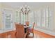 Charming dining area with hardwood floors, large windows, and an elegant chandelier at 2016 Westbourne Way, Johns Creek, GA 30022