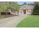 Beautiful brick home featuring a well manicured yard and a horseshoe driveway at 2016 Westbourne Way, Johns Creek, GA 30022