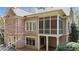 Exterior of brick home with screened in porch, patio, and backyard at 2016 Westbourne Way, Johns Creek, GA 30022