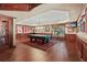 Spacious game room featuring a pool table, sports decor, and hardwood floors at 2016 Westbourne Way, Johns Creek, GA 30022