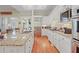 Open kitchen with granite countertops, stainless steel appliances, and bright lighting at 2016 Westbourne Way, Johns Creek, GA 30022