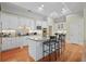 Bright kitchen featuring white cabinets, granite countertops, and a kitchen island at 2016 Westbourne Way, Johns Creek, GA 30022