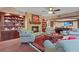 Basement living room featuring a stone fireplace, wood flooring, and a TV at 2016 Westbourne Way, Johns Creek, GA 30022