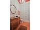 Stylish powder room with decorative wallpaper, ornate vanity, and elegant lighting at 2016 Westbourne Way, Johns Creek, GA 30022