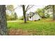 Spacious backyard with well-maintained lawn, mature trees, and space for recreation and outdoor activities at 2638 Cleburne Pkwy, Powder Springs, GA 30127