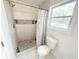 Bright bathroom showcasing a tile shower with decorative niches, modern fixtures, and natural light at 2638 Cleburne Pkwy, Powder Springs, GA 30127