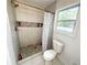 Bright bathroom features stand-up shower with pebble floor and mosaic tile at 2638 Cleburne Pkwy, Powder Springs, GA 30127