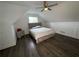 This modern bedroom features a sloped ceiling, dark floors, ceiling fan, and stylish decor at 2638 Cleburne Pkwy, Powder Springs, GA 30127