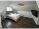 This modern bedroom features a sloped ceiling, dark floors, ceiling fan, and stylish decor at 2638 Cleburne Pkwy, Powder Springs, GA 30127