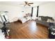 This bedroom features hardwood floors, ceiling fan, a couch, and a bed at 2638 Cleburne Pkwy, Powder Springs, GA 30127