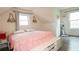 Bedroom features a sloped ceiling, wood floors, large windows, and cute decorations at 2638 Cleburne Pkwy, Powder Springs, GA 30127