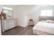 This bedroom features light wood floors, a dresser with a mirror, and a modern bed frame at 2638 Cleburne Pkwy, Powder Springs, GA 30127