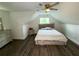 This modern bedroom features a sloped ceiling, dark floors, ceiling fan, and stylish decor at 2638 Cleburne Pkwy, Powder Springs, GA 30127