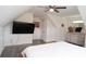 This bedroom features light wood floors, a TV, a ceiling fan, and a bright white color at 2638 Cleburne Pkwy, Powder Springs, GA 30127