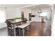 Open dining room with a modern table set, flowing into the updated kitchen with white cabinets and stainless steel appliances at 2638 Cleburne Pkwy, Powder Springs, GA 30127