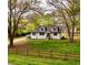 Charming two-story home featuring white siding, dormer windows, and a well-maintained front yard at 2638 Cleburne Pkwy, Powder Springs, GA 30127