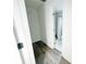 Hallway featuring hardwood floors, white walls, and a view into a bathroom with a shower at 2638 Cleburne Pkwy, Powder Springs, GA 30127