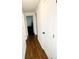 Hallway features hardwood floors, white walls, and doors leading to various rooms in the house at 2638 Cleburne Pkwy, Powder Springs, GA 30127