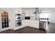 Well-appointed kitchen featuring white cabinets, stainless steel appliances, and an island, connecting seamlessly to the living area at 2638 Cleburne Pkwy, Powder Springs, GA 30127