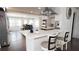 Kitchen island with seating and decorative accents, connecting the kitchen to a bright dining area with natural light at 2638 Cleburne Pkwy, Powder Springs, GA 30127