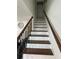 Interior staircase featuring wooden treads, sleek black metal railings, and modern design at 2638 Cleburne Pkwy, Powder Springs, GA 30127