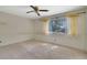 Bedroom with window with mini blinds and sheer curtains and tan carpet at 3312 Northcrest Rd # C, Atlanta, GA 30340