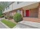 Charming brick townhouse with a bright red front door and well-maintained landscaping at 3312 Northcrest Rd # C, Atlanta, GA 30340