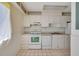 Functional kitchen featuring white appliances, tiled floors, and ample cabinet space at 3312 Northcrest Rd # C, Atlanta, GA 30340