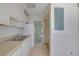 Practical kitchen with white cabinetry, tiled floor, and easy access to other areas of the home at 3312 Northcrest Rd # C, Atlanta, GA 30340