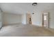 Bright, carpeted living room showcasing a staircase and doorways to other rooms at 3312 Northcrest Rd # C, Atlanta, GA 30340