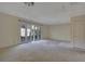 Large carpeted living room featuring neutral walls and a door that leads to the backyard at 3312 Northcrest Rd # C, Atlanta, GA 30340