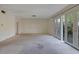 Inviting living room with light neutral walls, carpeted flooring, and a door to the back deck at 3312 Northcrest Rd # C, Atlanta, GA 30340